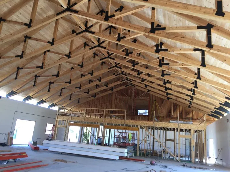 Heavy timber truss installed in a building