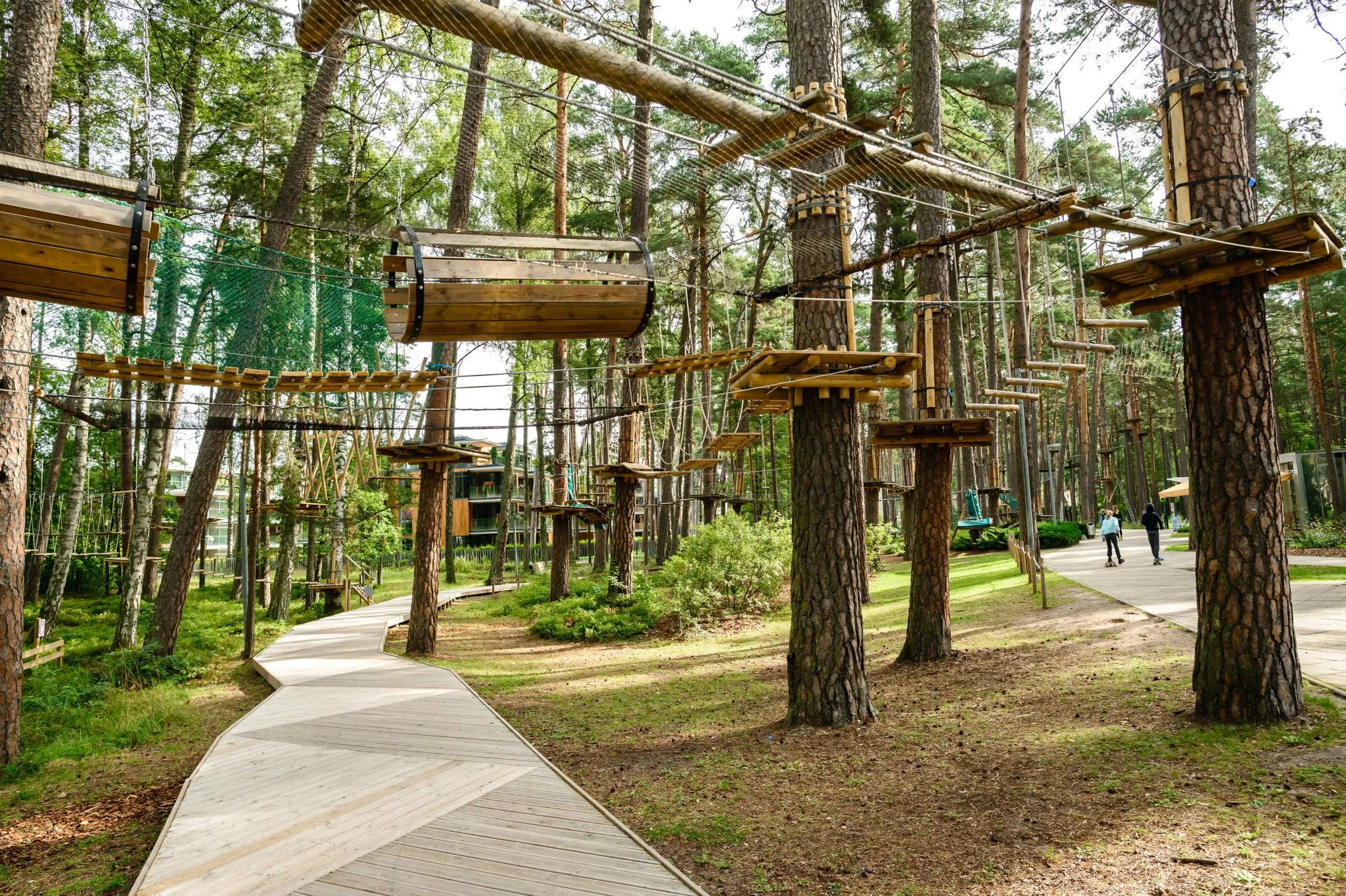 adventure climbing high wire park people on course in mountain helmet and safety equipment