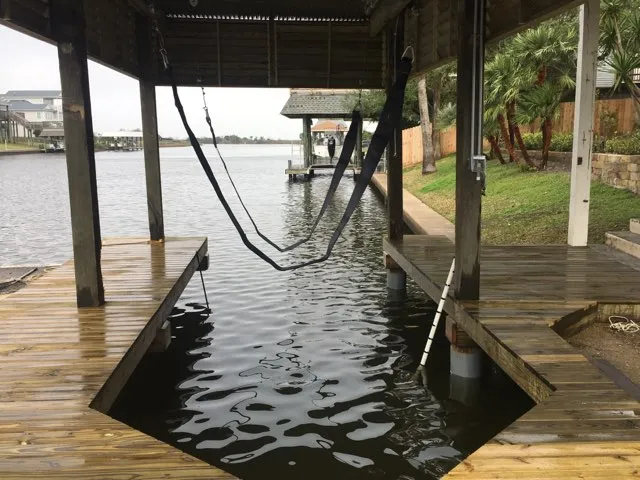 boat house with deck and dock