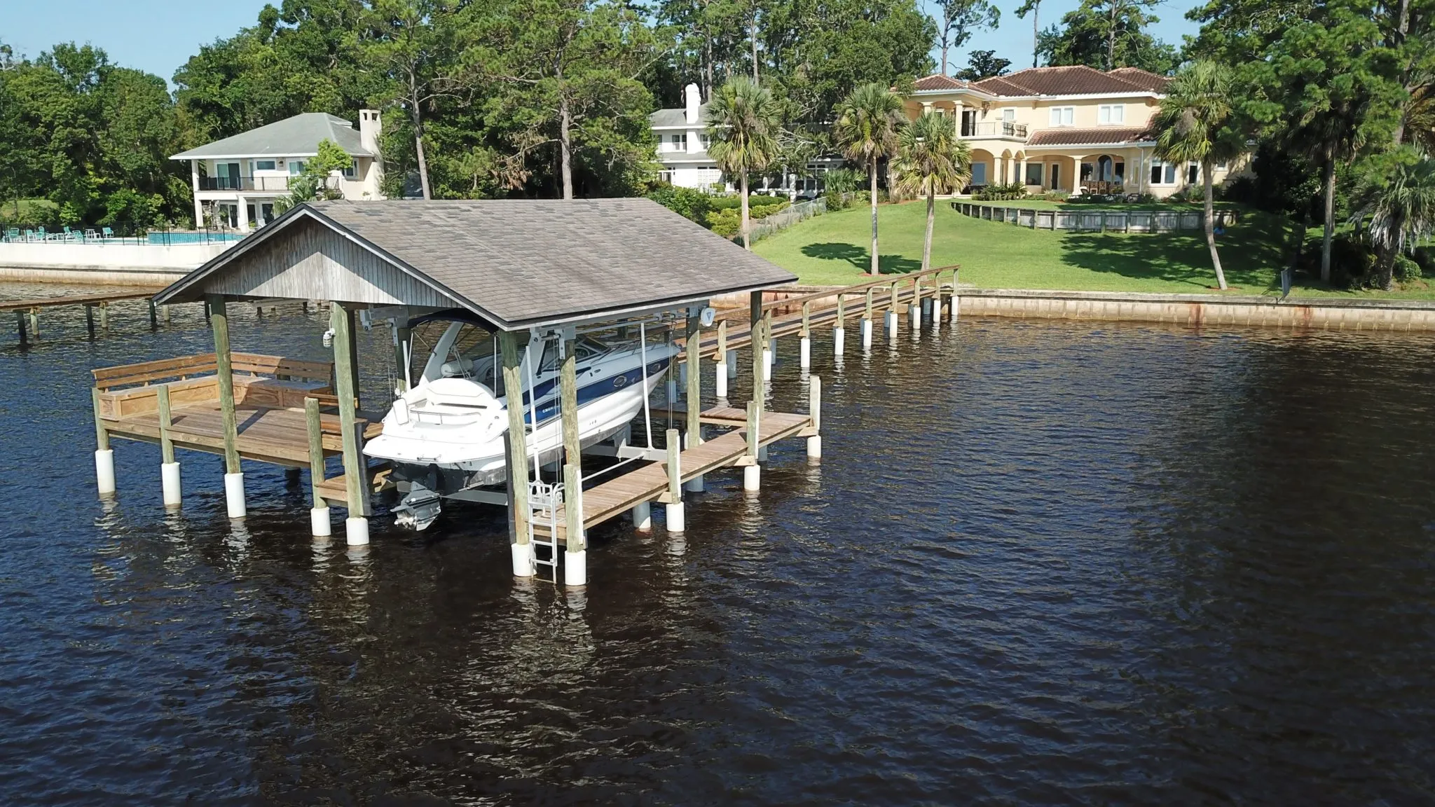 Aerial view of a waterfront boathouse and pier whose pilings were repaired with SnapJacket® sleeves