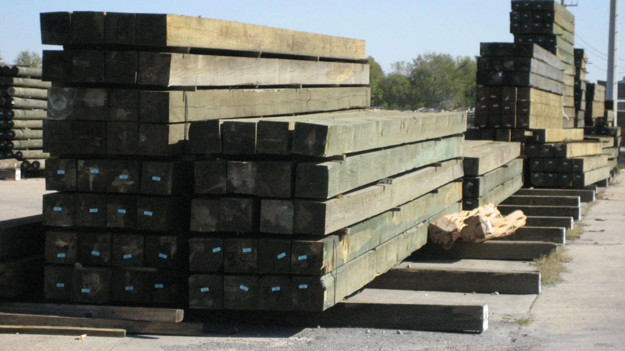 Stacks of large treated timbers