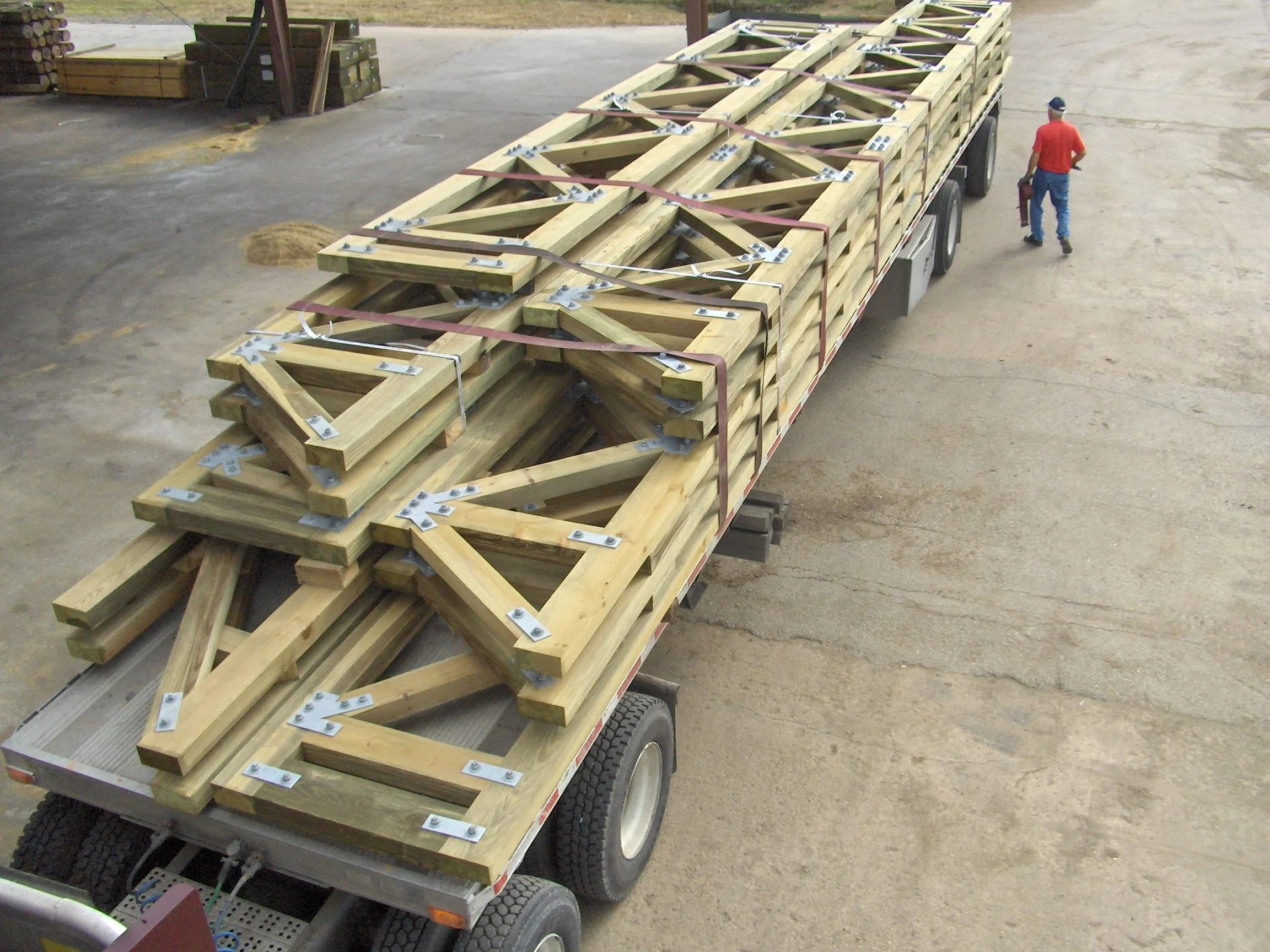 A truckload of large flat timber trusses loaded for delivery in the American Pole & Timber yard in Houston