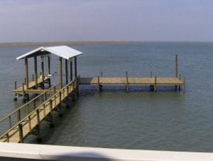 Custom boathouse pier built with American Pole & Timber pressure treated lumber