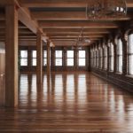 Empty room interior with rustic timbers and wood floors.