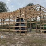 framing lumber and square timber pilings for barn
