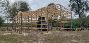 framing lumber and square timber pilings for barn