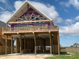 gun barrel pilings and timber truss beach home